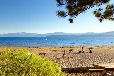 a group of people on a beach with the ocean at Private Ski, Lake & Golf Chalet! Walk to Lake in Tahoe Vista