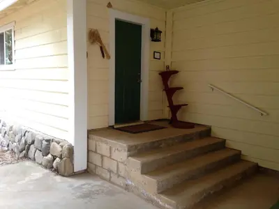a front door of a house with stairs and a green door at Black Oak Hill Vista near Yosemite - mountain views & starry night sky in Mariposa