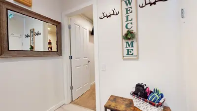 a hallway with a mirror and a basket of toothbrushes at Mammoth Estates #225 condo in Mammoth Lakes