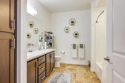 a bathroom with a sink and a toilet and a shower at Charming Patterson Condo with Grilling Stations in Patterson