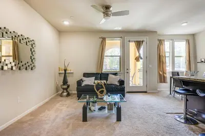 a living room with a couch and a table at Charming Patterson Condo with Grilling Stations in Patterson