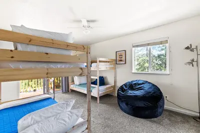 a bedroom with two bunk beds and a window at Big Creek Hideaway in Groveland