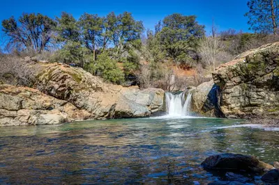 a waterfall in the middle of a river at Big Creek Hideaway in Groveland