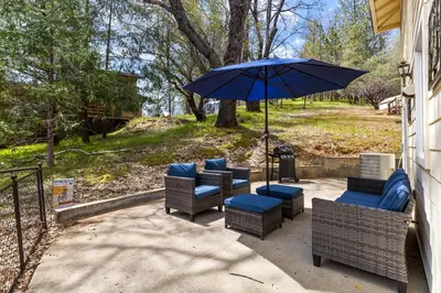 a group of chairs and an umbrella on a patio at Big Creek Hideaway in Groveland