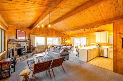 a large living room with a couch and a kitchen at Serene Groveland Cabin Rental Near Yosemite! in Groveland