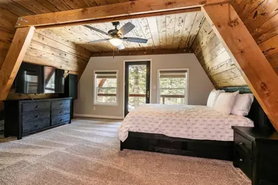 a bedroom with a bed and a wooden ceiling at Rustic and Modern 3BDR Tahoe Cabin in Tahoe City