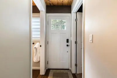 a hallway with a white door and a window at Rustic and Modern 3BDR Tahoe Cabin in Tahoe City