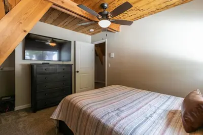 a bedroom with a ceiling fan and a dresser at Rustic and Modern 3BDR Tahoe Cabin in Tahoe City