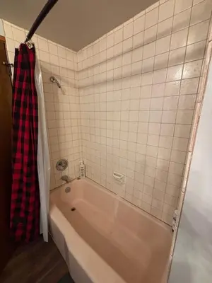 a bathroom with a tub and a tiled wall at Summer Escape Chalet with Pool Access in BLS in Arnold