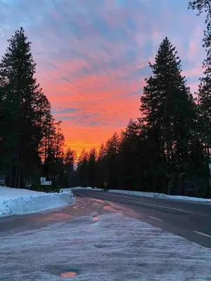 an empty road with a sunset in the background at Summer Escape Chalet with Pool Access in BLS in Arnold
