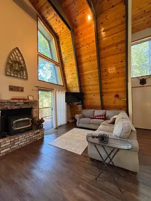 a living room with a couch and a fireplace at Summer Escape Chalet with Pool Access in BLS in Arnold
