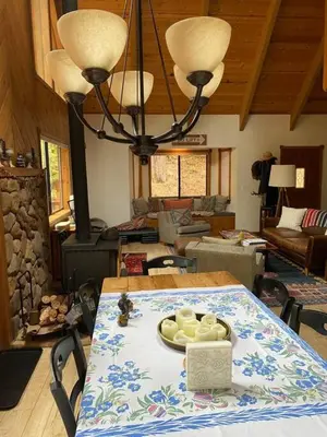 a table with a plate of food on top of it at Gorgeous cabin in BLS with EV Chgr, Pool Access and Gameroom in Arnold