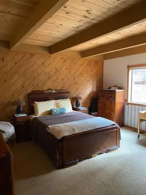 a bedroom with a large bed and a wooden ceiling at Gorgeous cabin in BLS with EV Chgr, Pool Access and Gameroom in Arnold