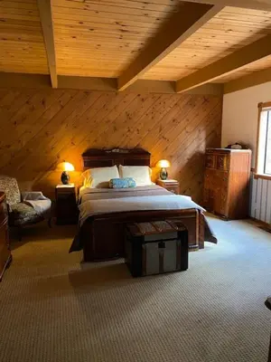 a bedroom with a bed and a wooden ceiling at Gorgeous cabin in BLS with EV Chgr, Pool Access and Gameroom in Arnold