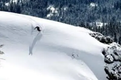 a person is skiing down a snow covered slope at Gorgeous cabin in BLS with EV Chgr, Pool Access and Gameroom in Arnold