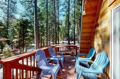 four blue chairs sitting on the porch of a cabin at Peaceful Pine Getaway in Dorrington