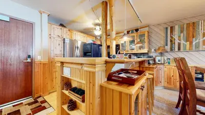 a kitchen with wooden cabinets and a counter top at Aspen Creek #227 condo in Mammoth Lakes