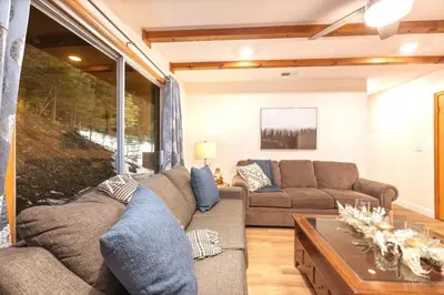 a living room with a couch and a table at Corlieu Falls Cabin in Sugar Pine 8 miles from Yosemite with Gazebo, Hot tub a shack and Bar top in Oakhurst