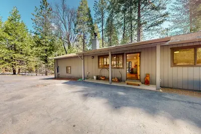 a home in the woods with a driveway at Piney Point in Arnold