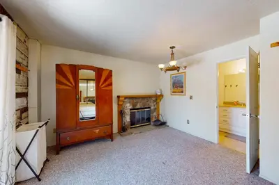 a living room with a fireplace and a mirror at Beaver Lodge in South Lake Tahoe