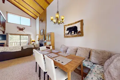 a living room with a table and a couch at Beaver Lodge in South Lake Tahoe