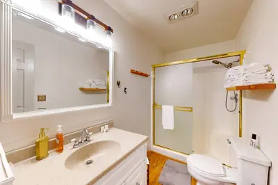 a bathroom with a sink and a toilet and a mirror at Beaver Lodge in South Lake Tahoe
