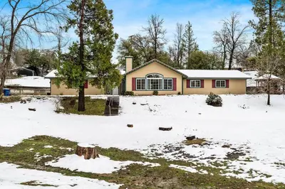 a house with snow in front of it at Country Club Hideout - w/ HotTub, King bed in Oakhurst