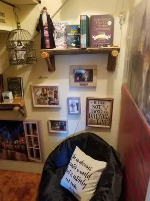 a room with a chair with a pillow on a wall at Uncle Grizz's Cabin...get intouch with nature in Bass Lake Annex
