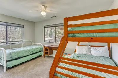 a bedroom with two bunk beds and a desk at Oakhurst Vacation Rental Near Hiking and Bass Lake! in Oakhurst