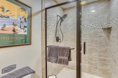 a bathroom with a shower with a glass door at Oakhurst Vacation Rental Near Hiking and Bass Lake! in Oakhurst