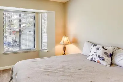 a bedroom with a bed with a pillow and a window at Oakhurst Vacation Rental Near Hiking and Bass Lake! in Oakhurst