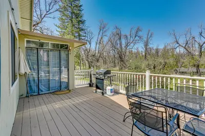 a deck with a grill and a table and chairs at Oakhurst Vacation Rental Near Hiking and Bass Lake! in Oakhurst